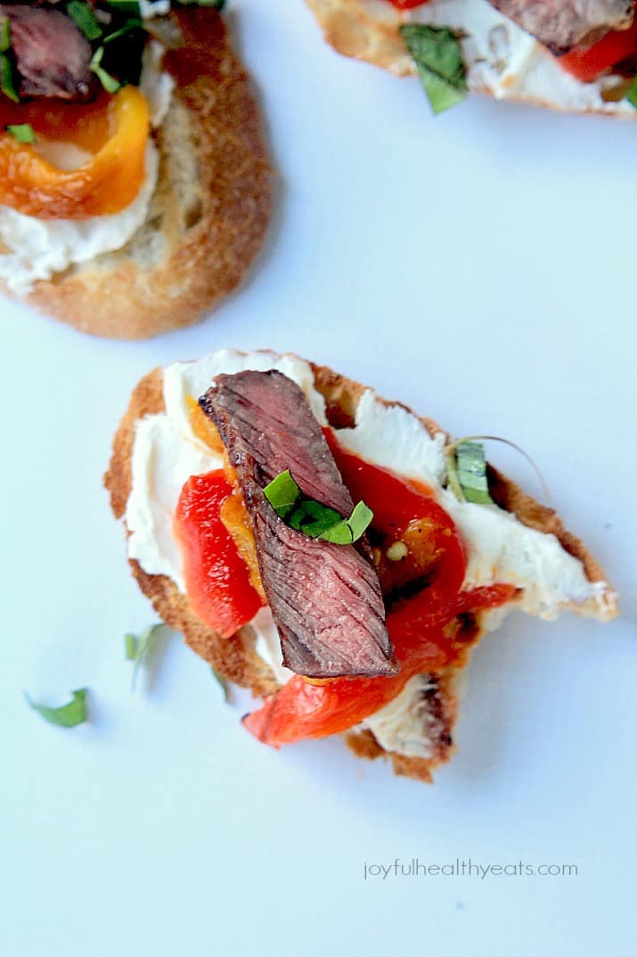 Top view of Grilled Ribeye & Roasted Pepper Bruschetta with Whipped Goat Cheese on crostini