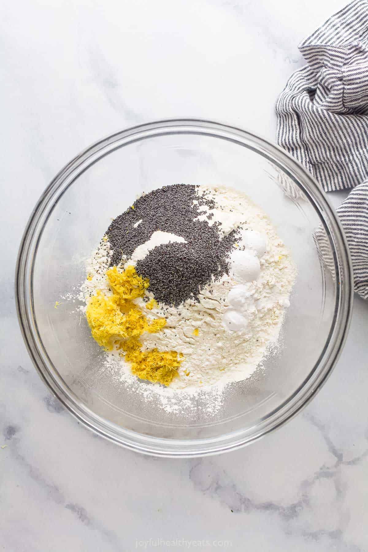 This lemon poppy seed bread is a zesty dessert-turned-breakfast packed with healthy ingredients like Greek yogurt for a guilt-free treat. Mixing the dry ingredients.