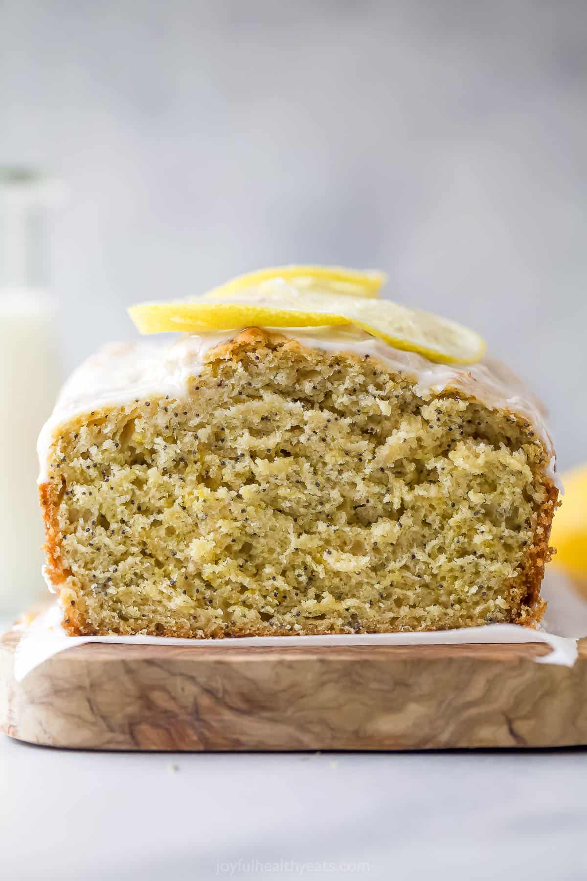 This lemon poppy seed bread is a zesty dessert-turned-breakfast packed with healthy ingredients like Greek yogurt for a guilt-free treat. Close-up of moist crumb in the loaf.