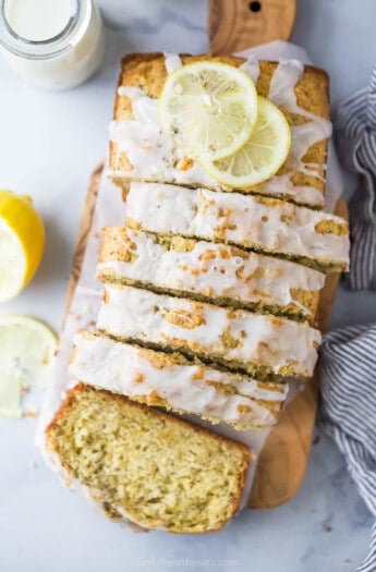 Sliced lemon poppy seed bread with glaze on top.