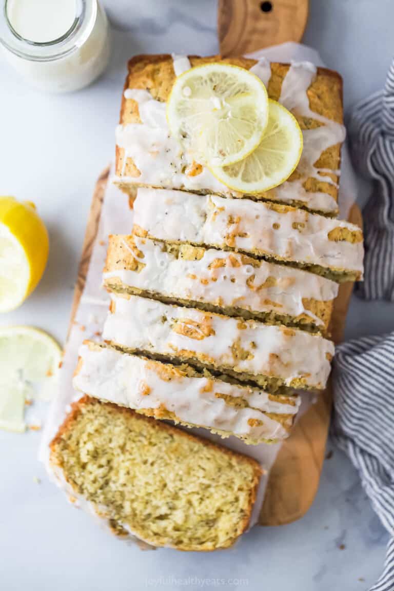 Sliced lemon poppy seed bread with glaze on top.