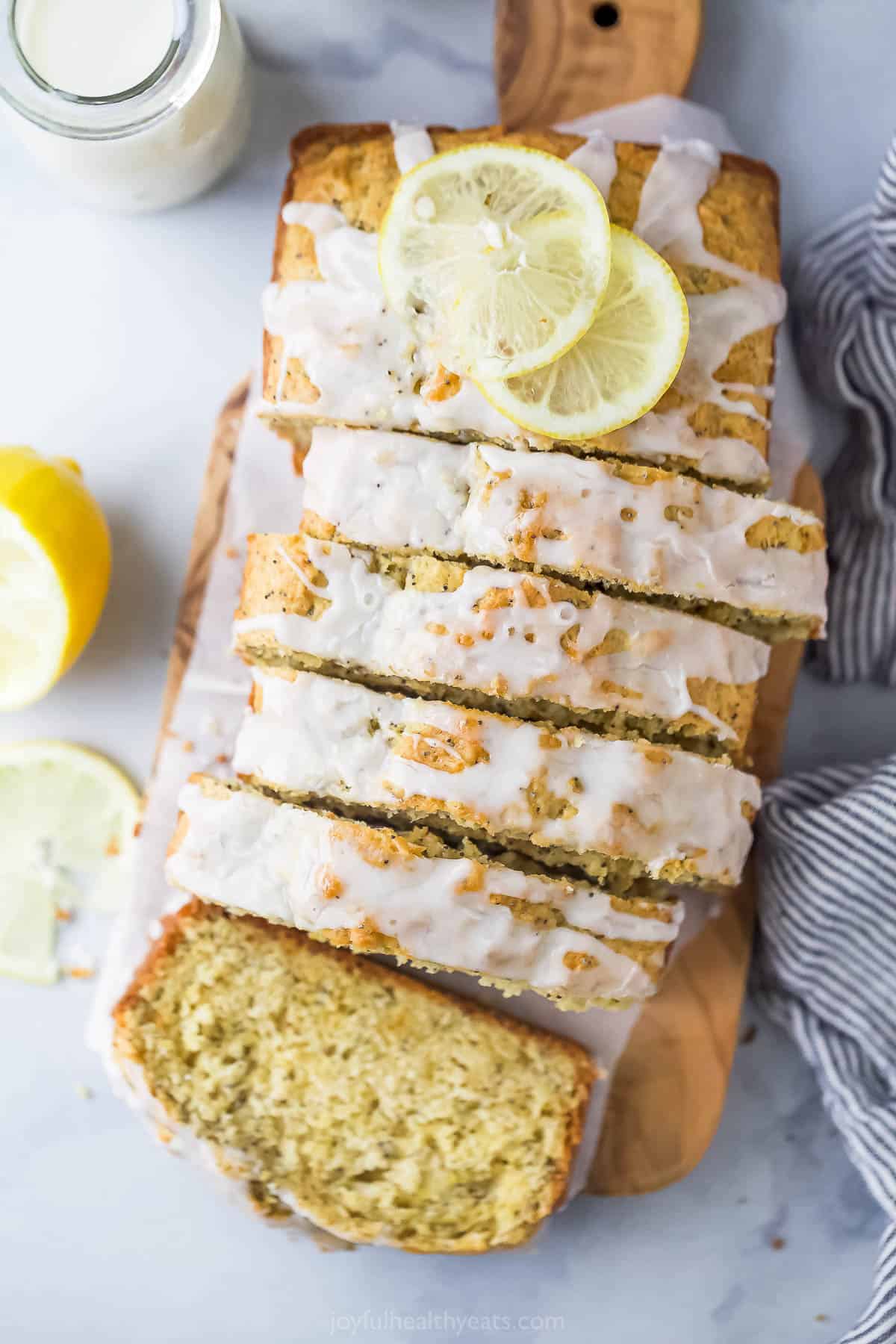 Sliced lemon poppy seed bread with glaze on top. 