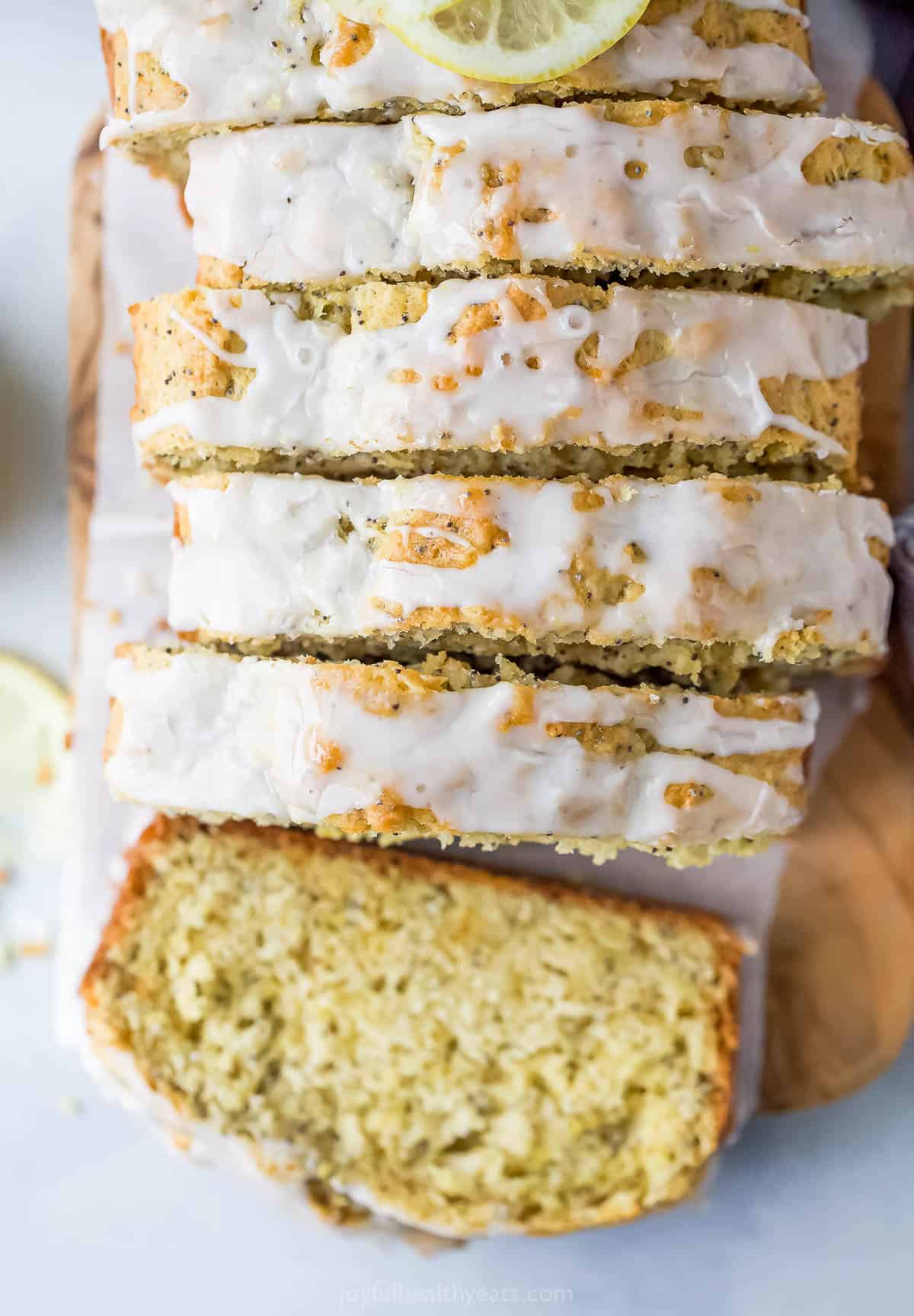 Glazed and sliced lemon poppy loaf.