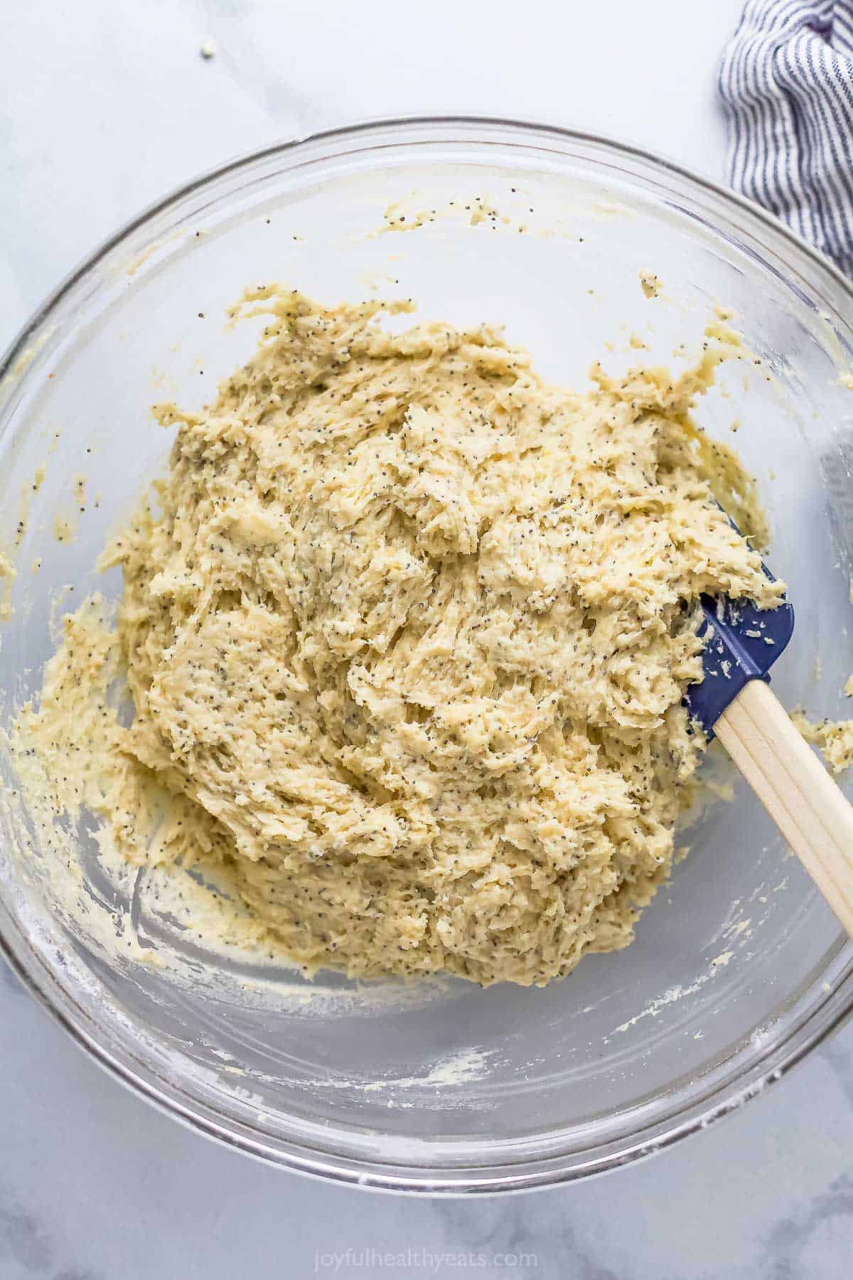 This lemon poppy seed bread is a zesty dessert-turned-breakfast packed with healthy ingredients like Greek yogurt for a guilt-free treat. Mixing the batter.