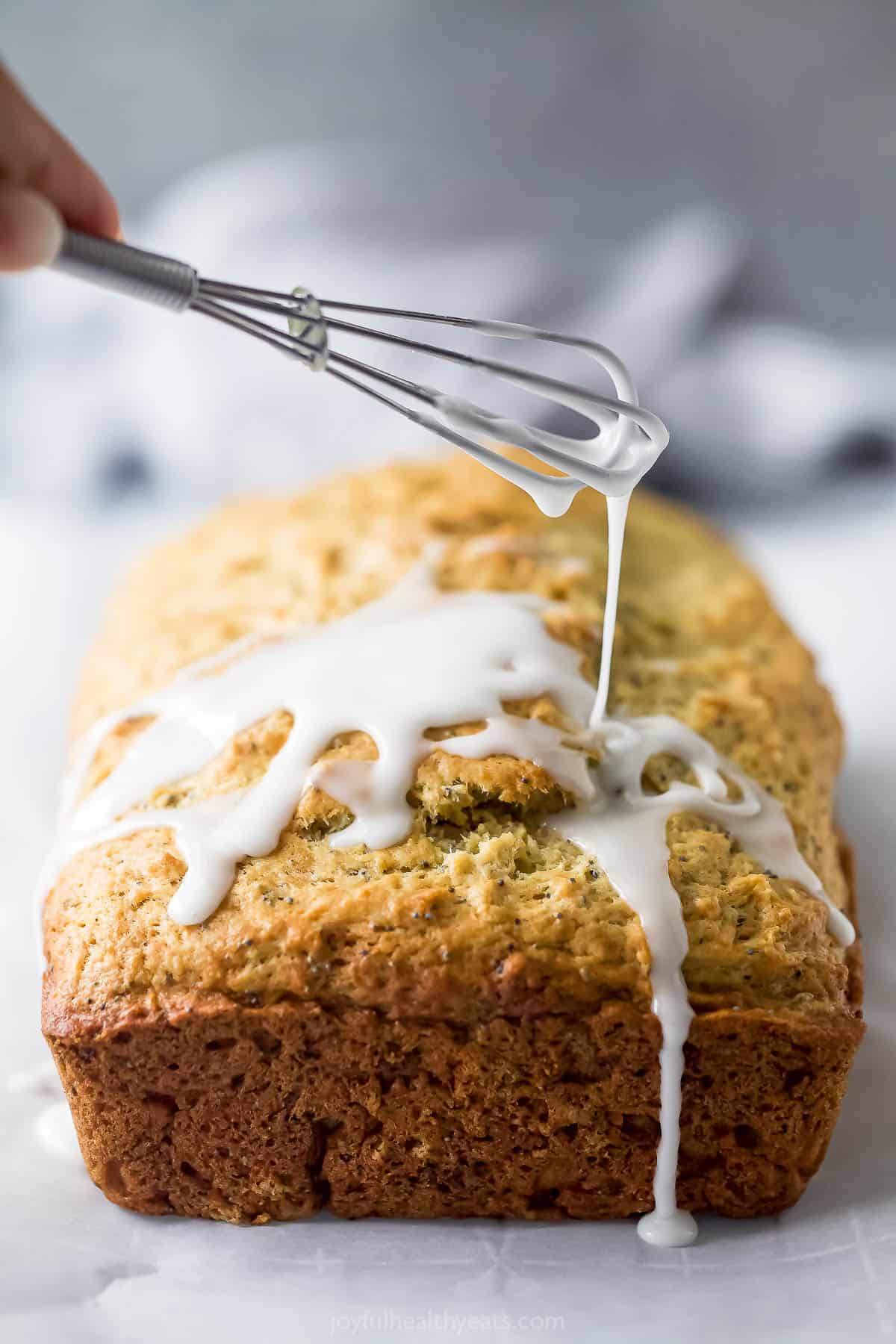 Drizzling the glaze over the loaf. 