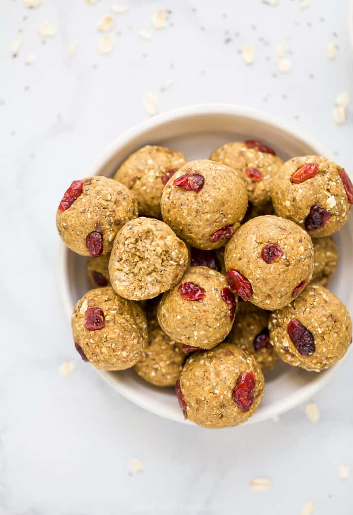 a bowl filled with pumpkin protein balls with cranberries