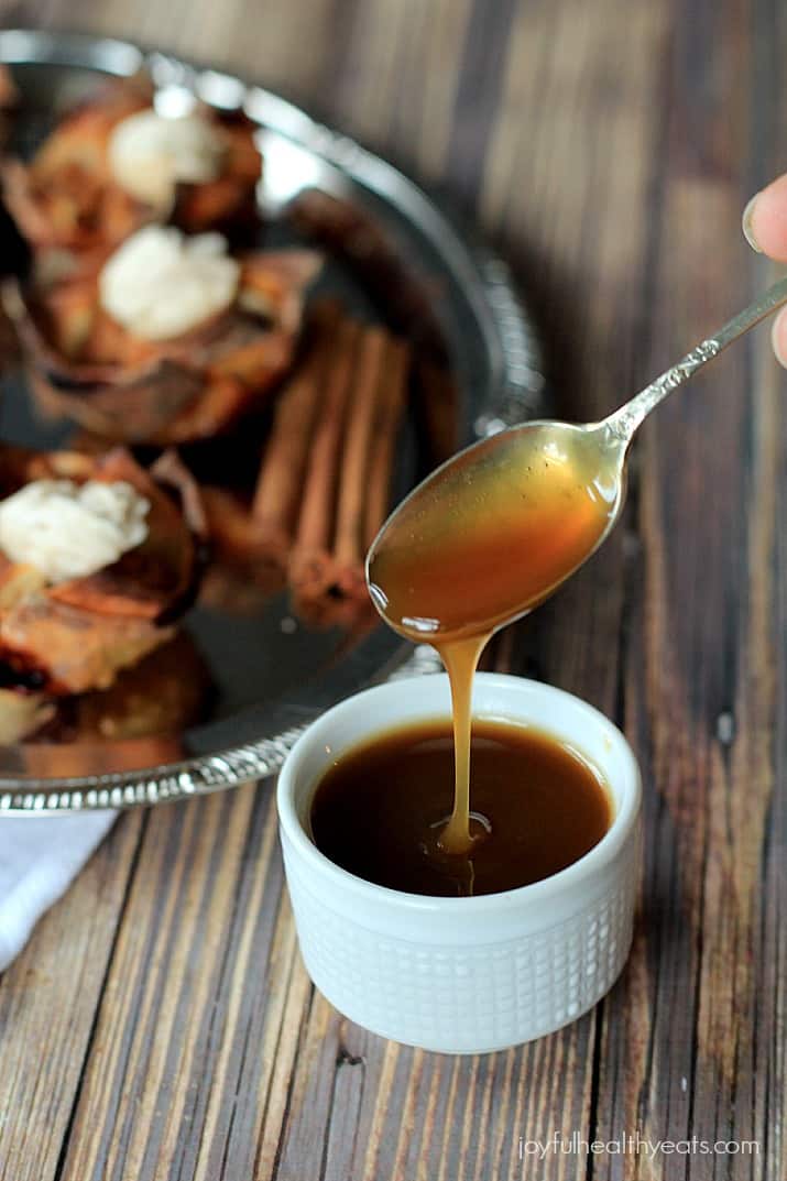 A ramekin of caramel sauce with a spoon