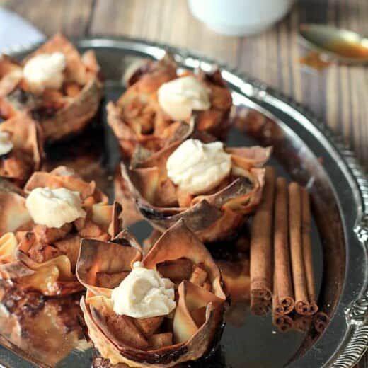 Apple Pie Wonton Cups on a Serving Tray with Cinnamon Sticks