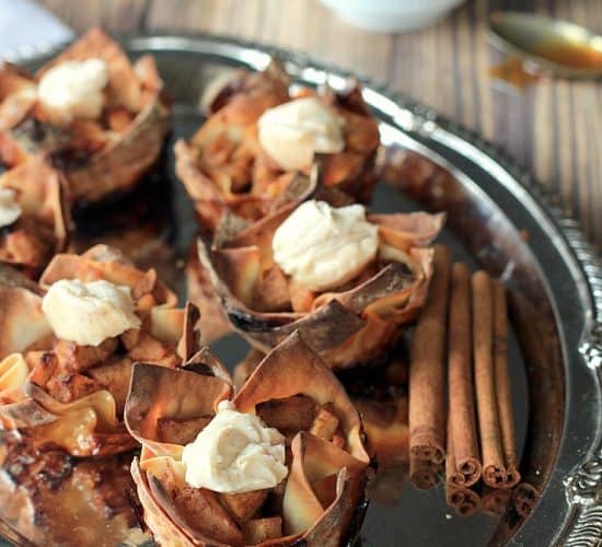 Apple Pie Wonton Cups on a Serving Tray with Cinnamon Sticks