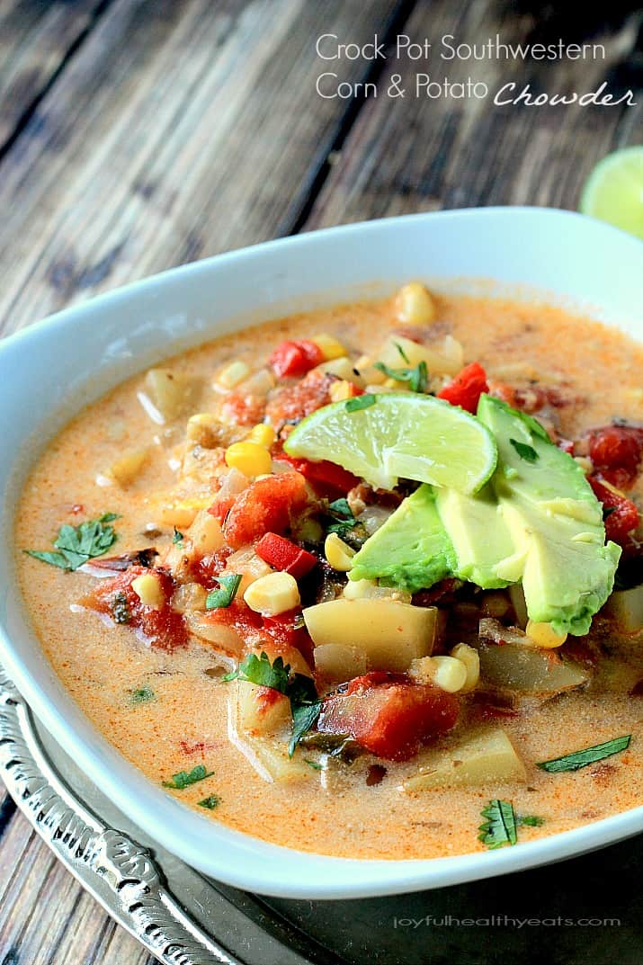 A bowl of Crock Pot Southwestern Corn & Potato Chowder topped with sliced avocado and lime