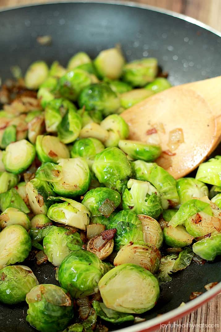 Pan Sauteed Brussels Sprouts with sweet Caramelized Onions and salty crispy Bacon, the ultimate holiday side dish recipe! | www.joyfulhealthyeats.com #ALDIholiday #paleo #glutenfree