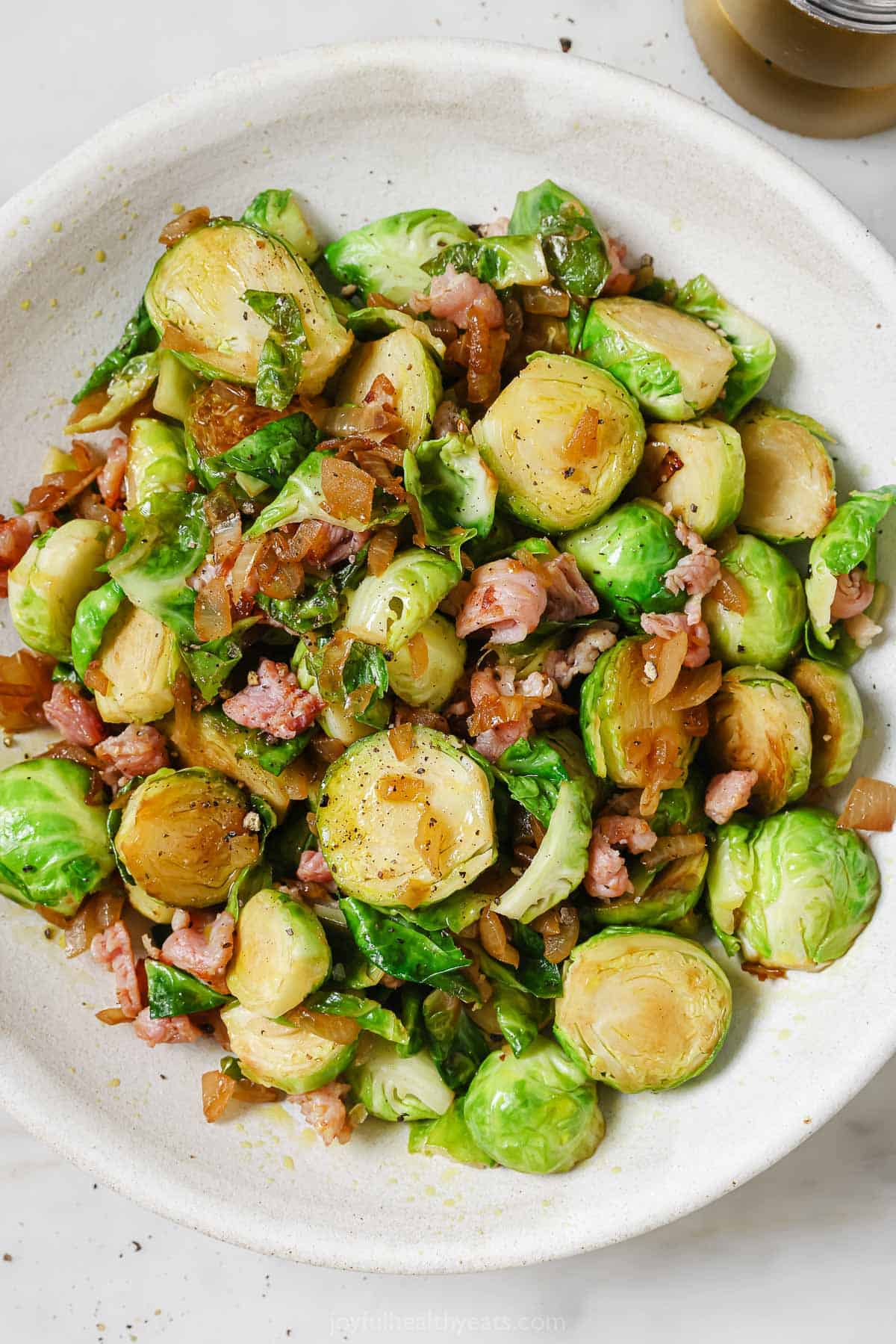 Sauteed brussels sprouts  in a serving bowl. 