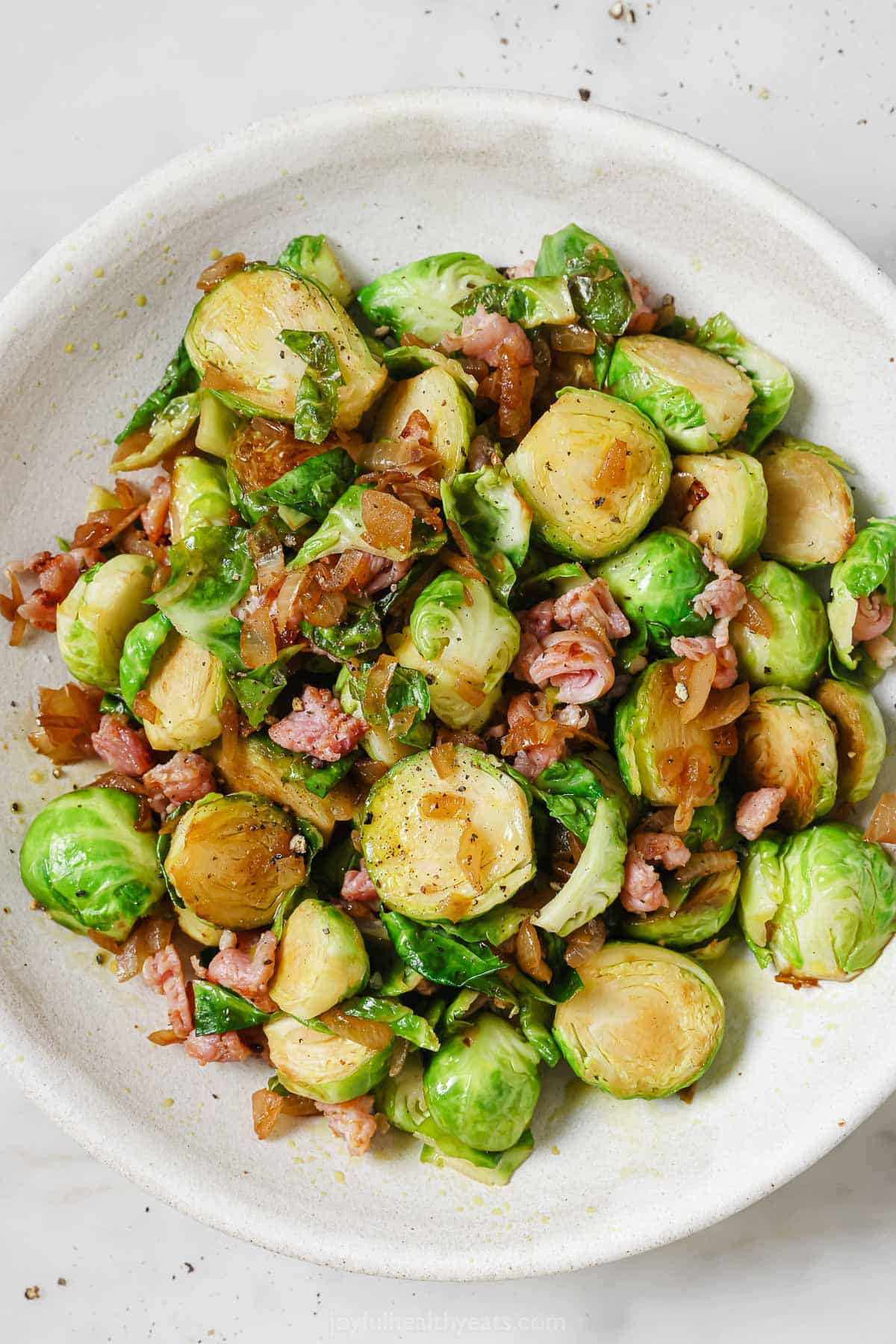 Brussels sprouts with bacon in a serving bowl. 