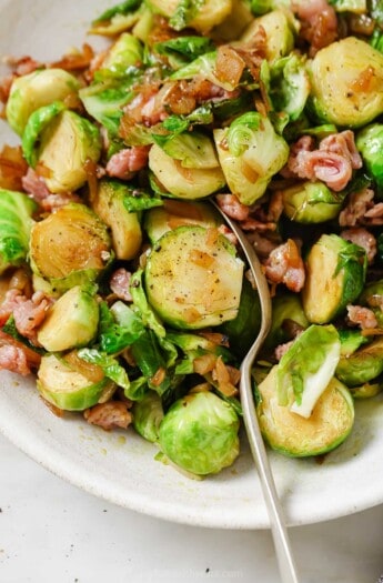 Grabbing a brussels sprout with a spoon.