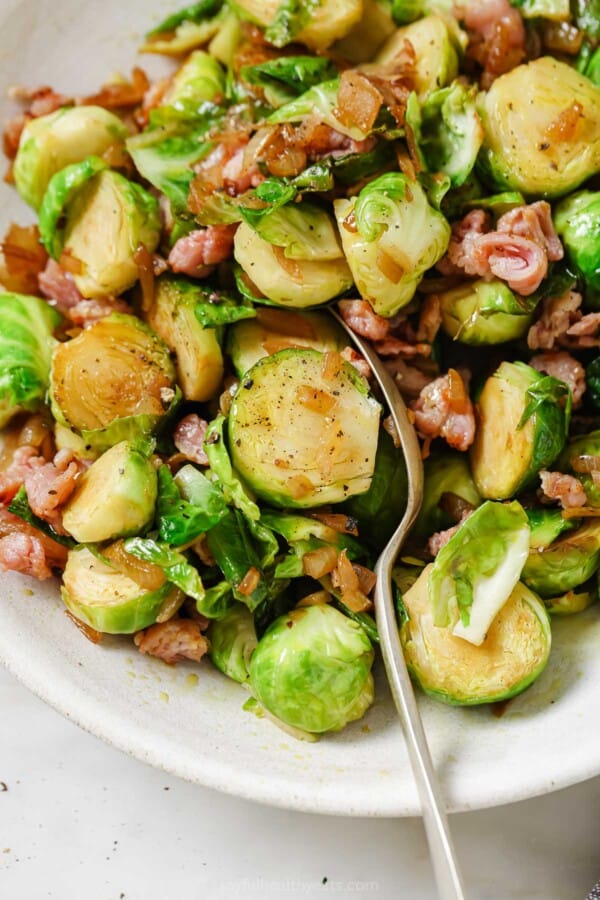 Grabbing a brussels sprout with a spoon.