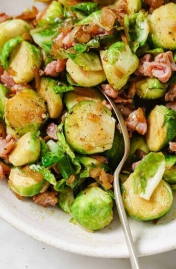 Grabbing a brussels sprout with a spoon.