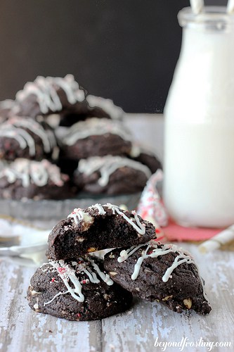 Three Double Chocolate Candy Cane Cookies Next to a Bottle of Milk and More Cookies