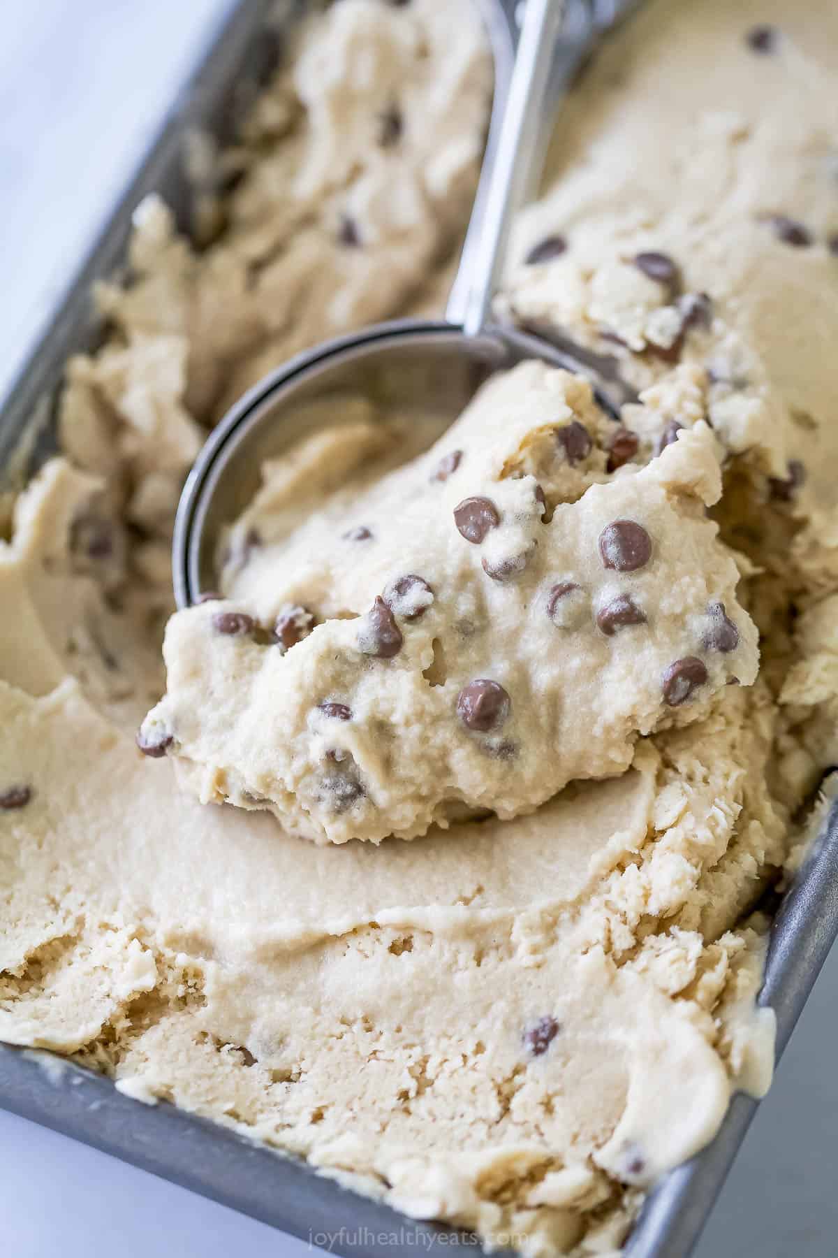 This dairy-free Espresso Ice Cream is full of coffee flavor and dotted with chocolate chips—because everything’s better with chocolate! Scooping espresso ice cream from loaf pan