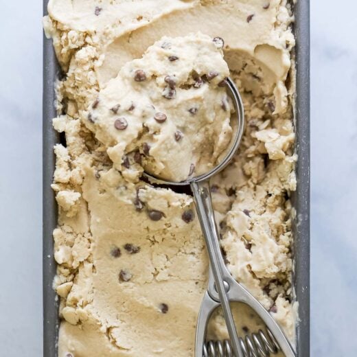 Ice cream scoop in container of espresso ice cream with chocolate chips