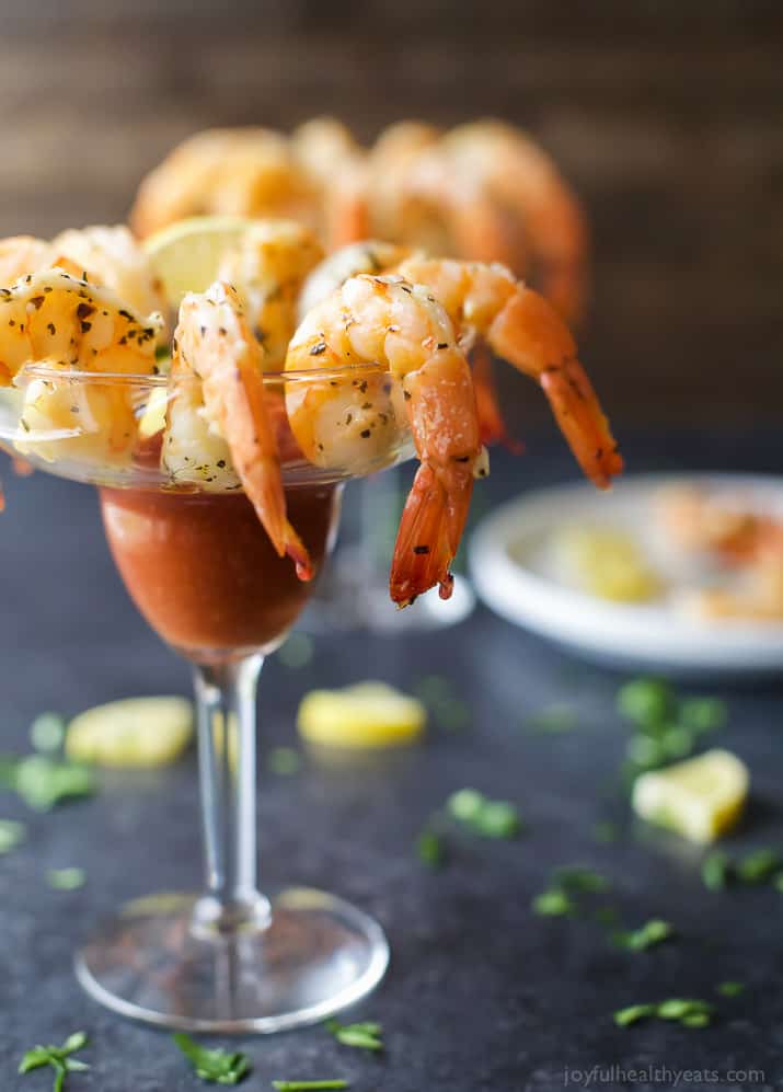 Garlic Herb Roasted Shrimp around the rim of a glass with Cocktail Sauce