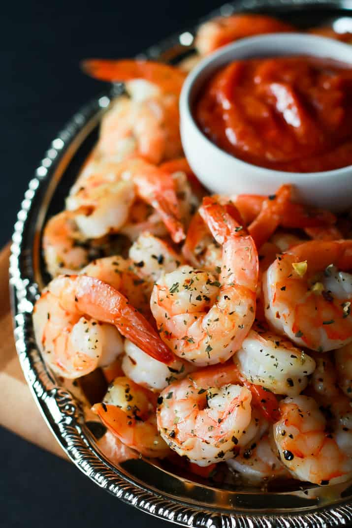 A Platter of Shrimp with a Small Bowl of Cocktail Sauce in the Middle