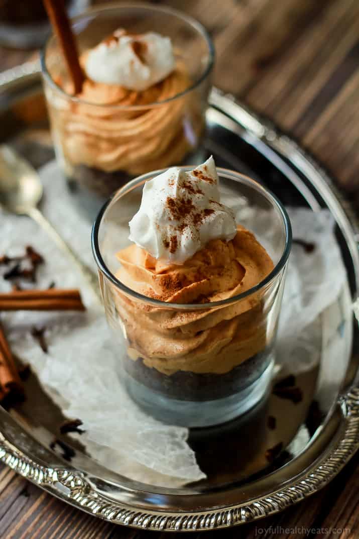 A Close-Up Shot of a No Bake Pumpkin Cheesecake in a Glass on Top of a Serving Platter