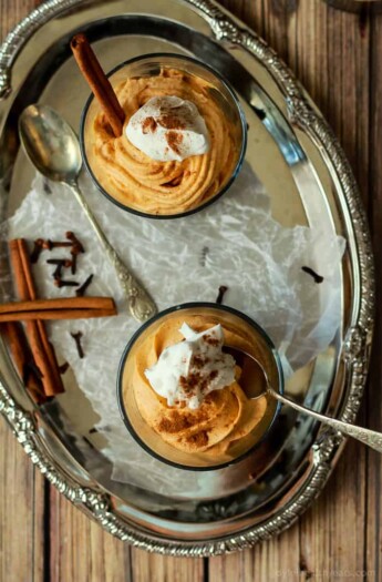 Two Homemade Thanksgiving Cheesecakes with Cool Whip and Cinnamon on Top