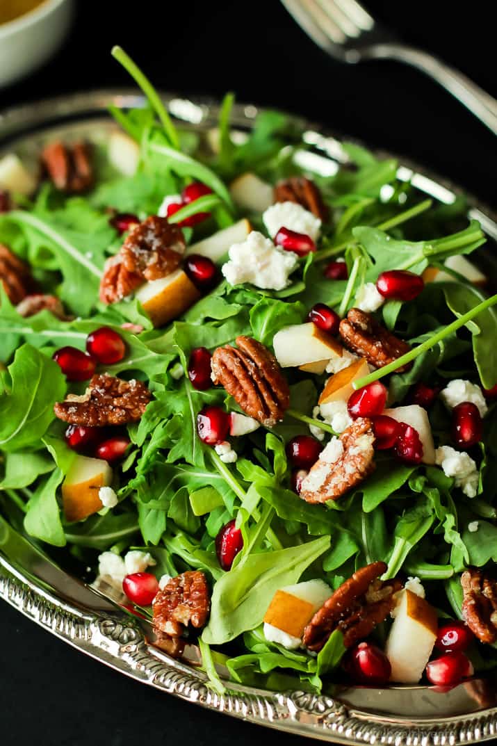 Pomegranate Goat Cheese Candied Pecan Arugula Salad. The perfect salad to change up your holiday menu, easy to make and absolutely delicious! | www.joyfulhealthyeats.com