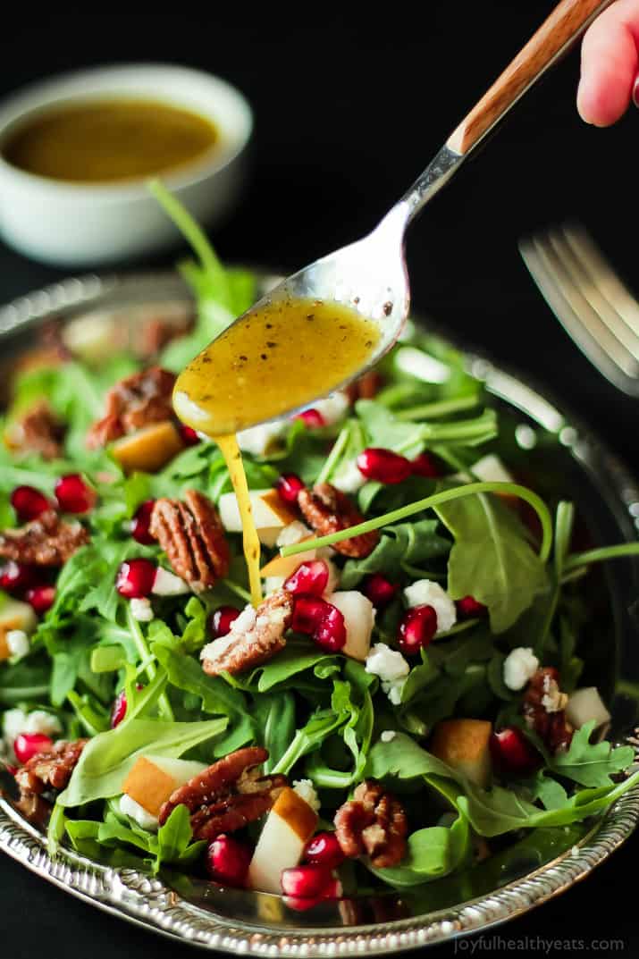 Pomegranate Goat Cheese Candied Pecan Arugula Salad. The perfect salad to change up your holiday menu, easy to make and absolutely delicious! | www.joyfulhealthyeats.com