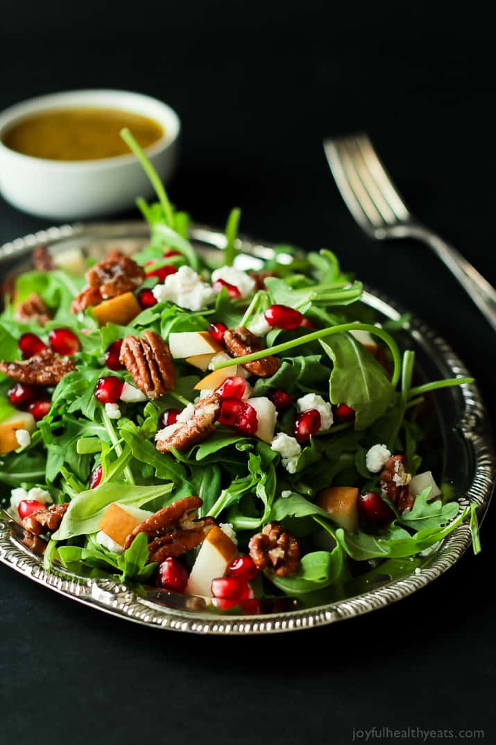 Pomegranate Goat Cheese Candied Pecan Arugula Salad. The perfect salad to change up your holiday menu, easy to make and absolutely delicious! | www.joyfulhealthyeats.com