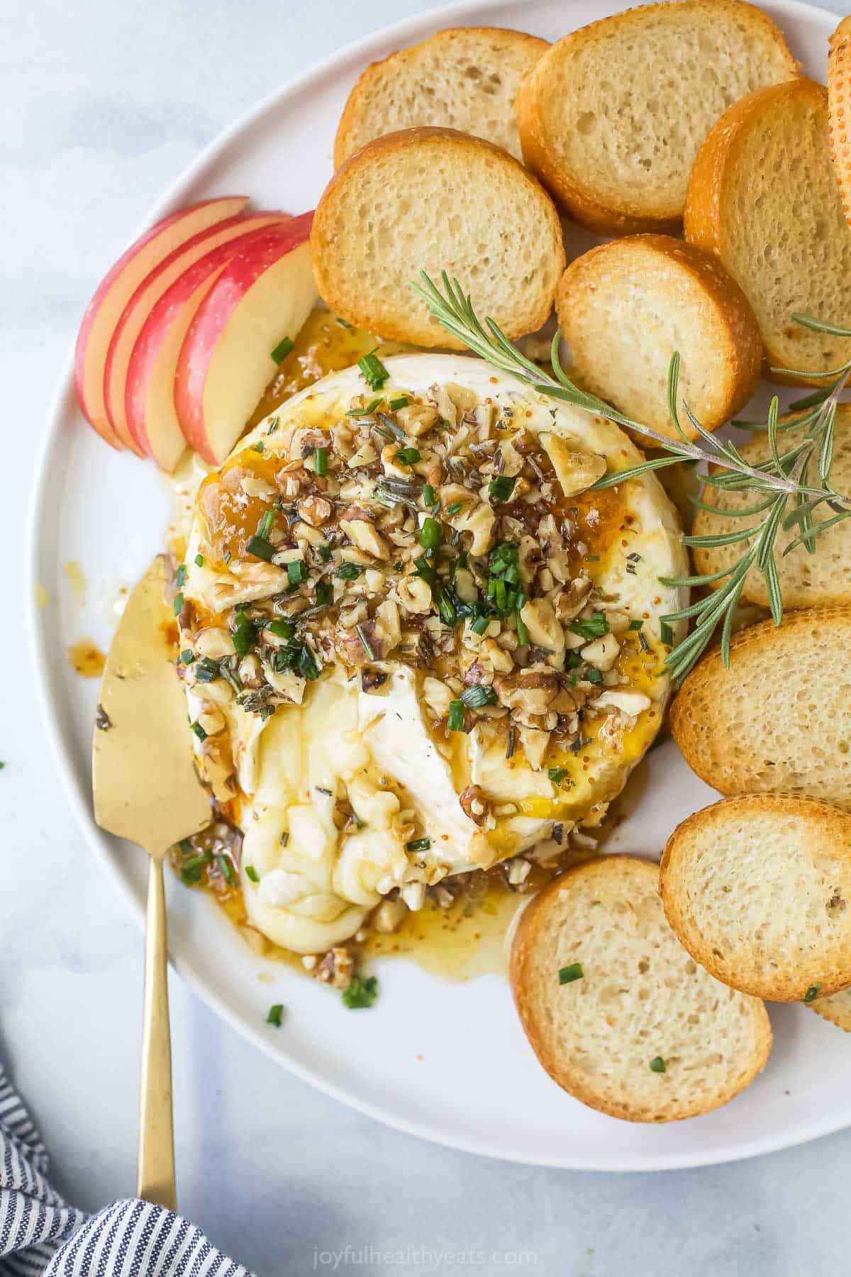 Gooey baked brie with fig jam and sliced apples.