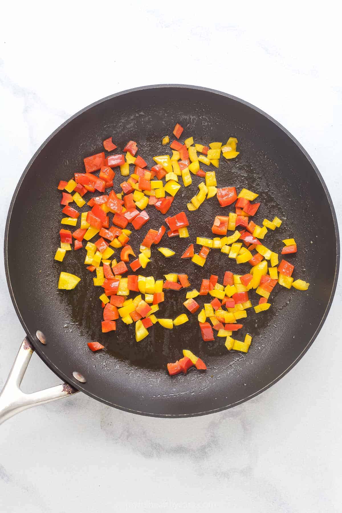 Cooking the peppers in a pan. 