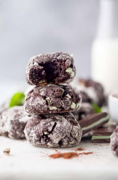 chocolate crinkle cookies stacked on top of each other