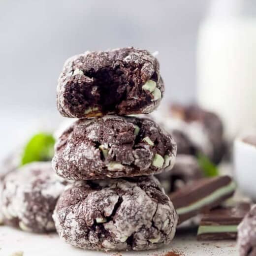 chocolate crinkle cookies stacked on top of each other