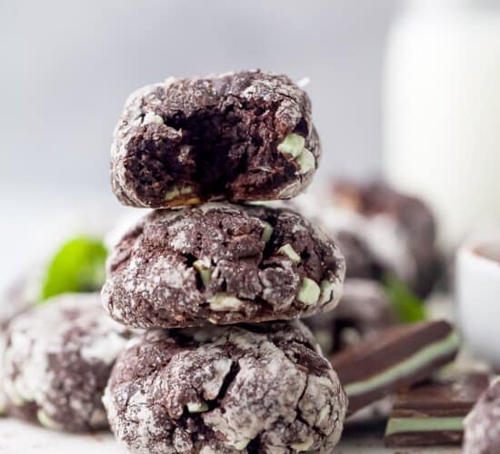 chocolate crinkle cookies stacked on top of each other