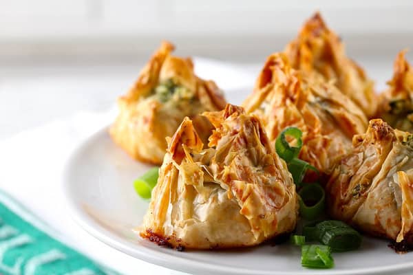 Five Scallop and Pesto Purses on a White Plate