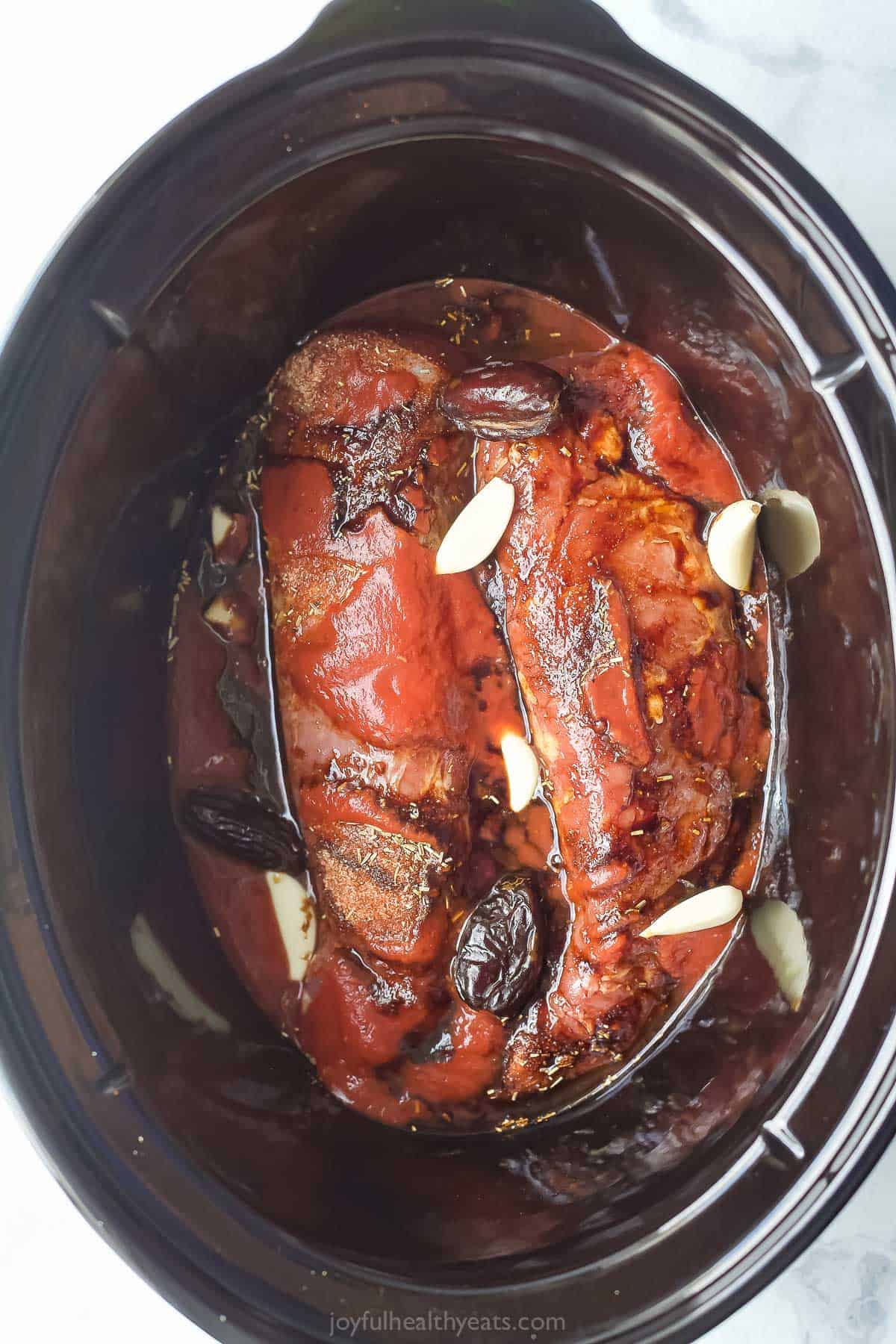 Ingredients for pulled pork sliders in slow cooker before cooking.