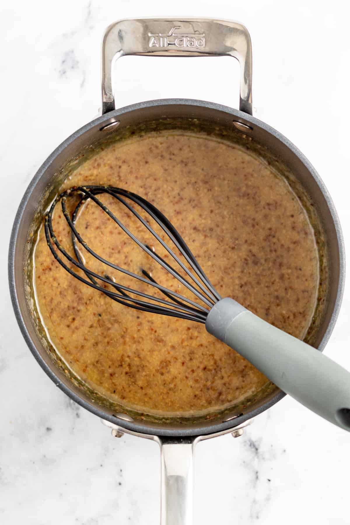 saucepan with mustard brown sauce