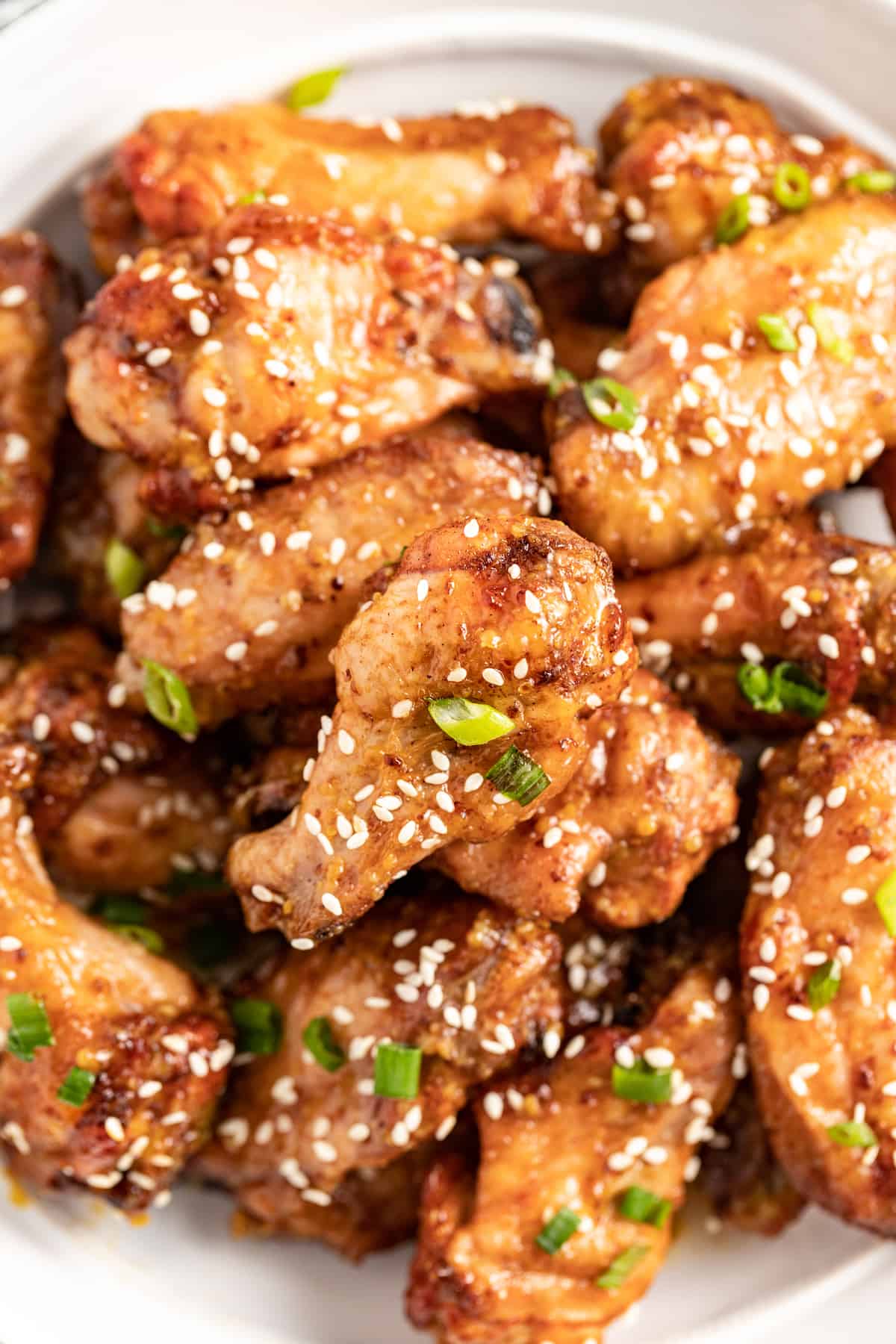 Honey Mustard Baked Chicken Wings are a fun appetizer to make for your next party. It has an easy honey mustard saucethat everyone will love. a platter of honey mustard baked chicken wings