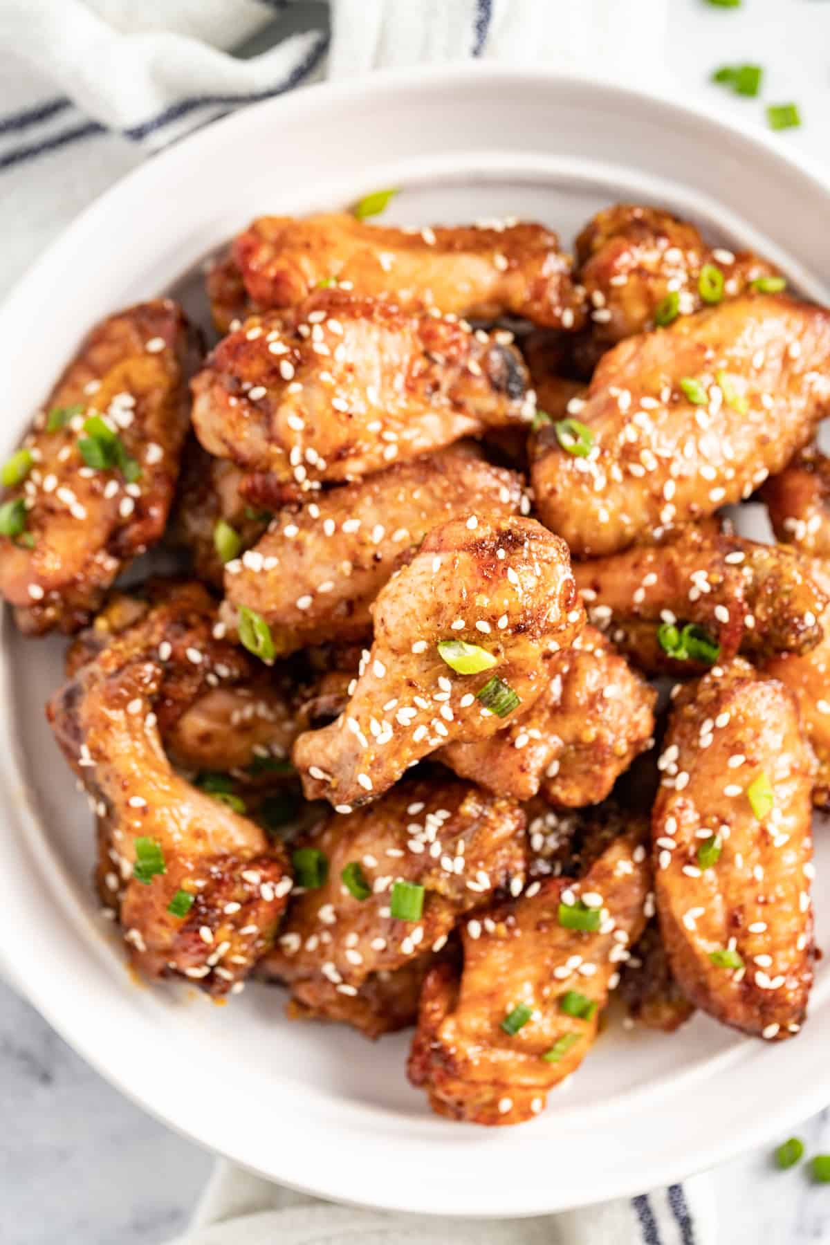 Honey Mustard Baked Chicken Wings are a fun appetizer to make for your next party. It has an easy honey mustard saucethat everyone will love. a platter of honey mustard baked chicken wings