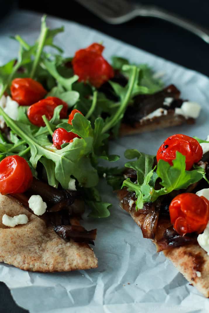 Close-up image of Pita Pizza with Balsamic Caramelized Onions, Arugula, Feta and Tomatoes