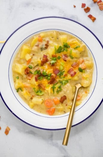 Overhead view of creamy potato leek soup in bowl with spoon