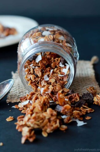 A Jar On its Side Pouring Out Homemade Almond Joy Granola