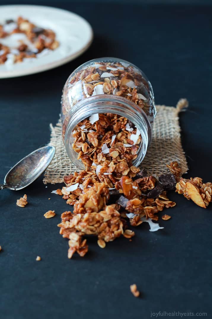 The Best Homemade Almond Joy Granola made in just 30 minutes! This stuff is like candy its so addicting. From the dark chocolate chunks, to the coconut flakes, and the cinnamon toasted granola. You need this recipe! | joyfulhealthyeats.com #recipes