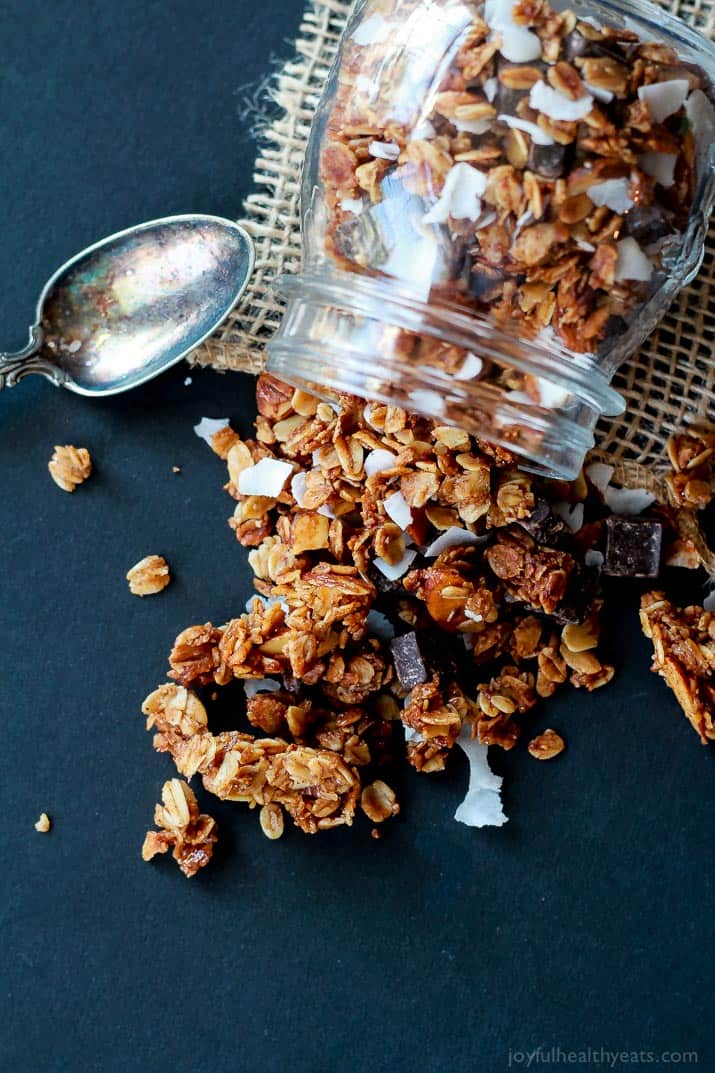 The Best Homemade Almond Joy Granola made in just 30 minutes! This stuff is like candy its so addicting. From the dark chocolate chunks, to the coconut flakes, and the cinnamon toasted granola. You need this recipe! | joyfulhealthyeats.com #recipes