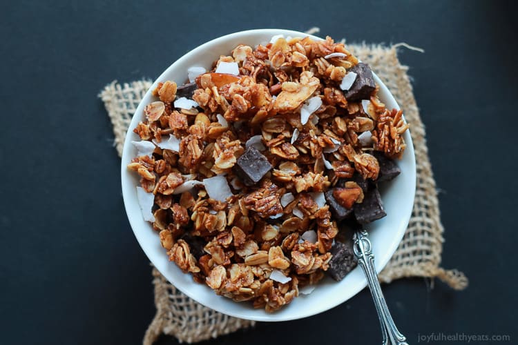 The Best Homemade Almond Joy Granola made in just 30 minutes! This stuff is like candy its so addicting. From the dark chocolate chunks, to the coconut flakes, and the cinnamon toasted granola. You need this recipe! | joyfulhealthyeats.com #recipes