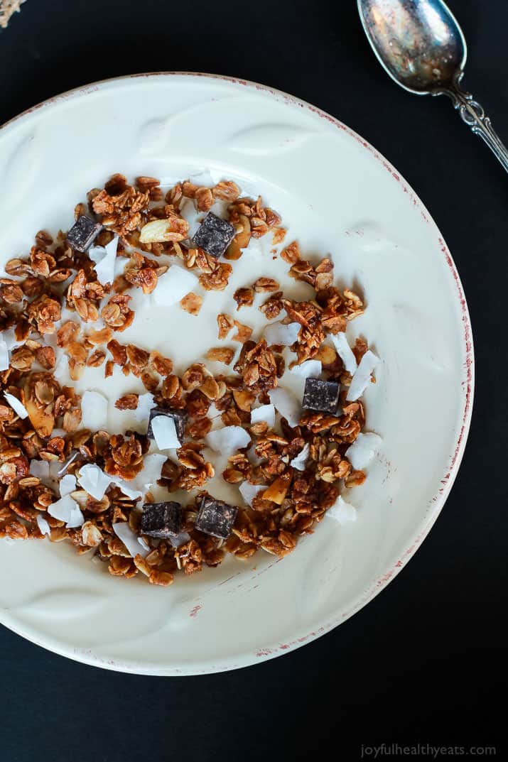 The Best Homemade Almond Joy Granola made in just 30 minutes! This stuff is like candy its so addicting. From the dark chocolate chunks, to the coconut flakes, and the cinnamon toasted granola. You need this recipe! | joyfulhealthyeats.com #recipes