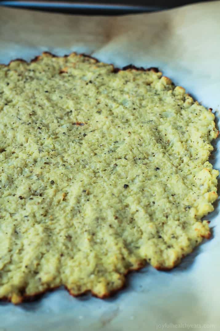 Done in 30 Minutes! An Easy Gluten Free Herb Cauliflower Pizza Crust recipe that is full of flavor and takes less time to make them homemade pizza dough. | joyfulhealthyeats.com #recipe