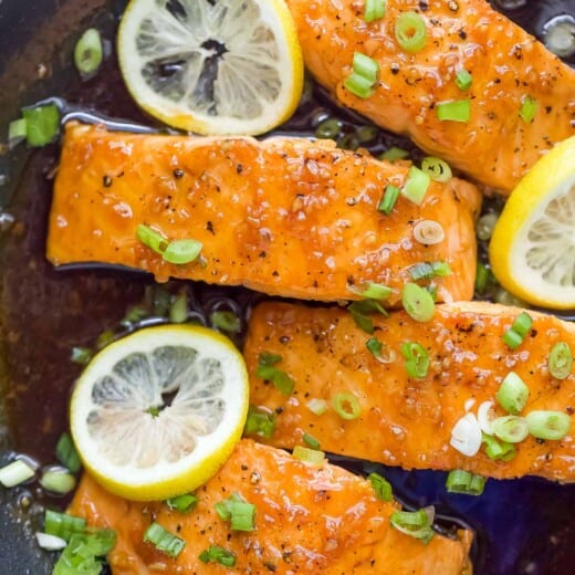 Salmon fillets with honey glaze in the skillet.