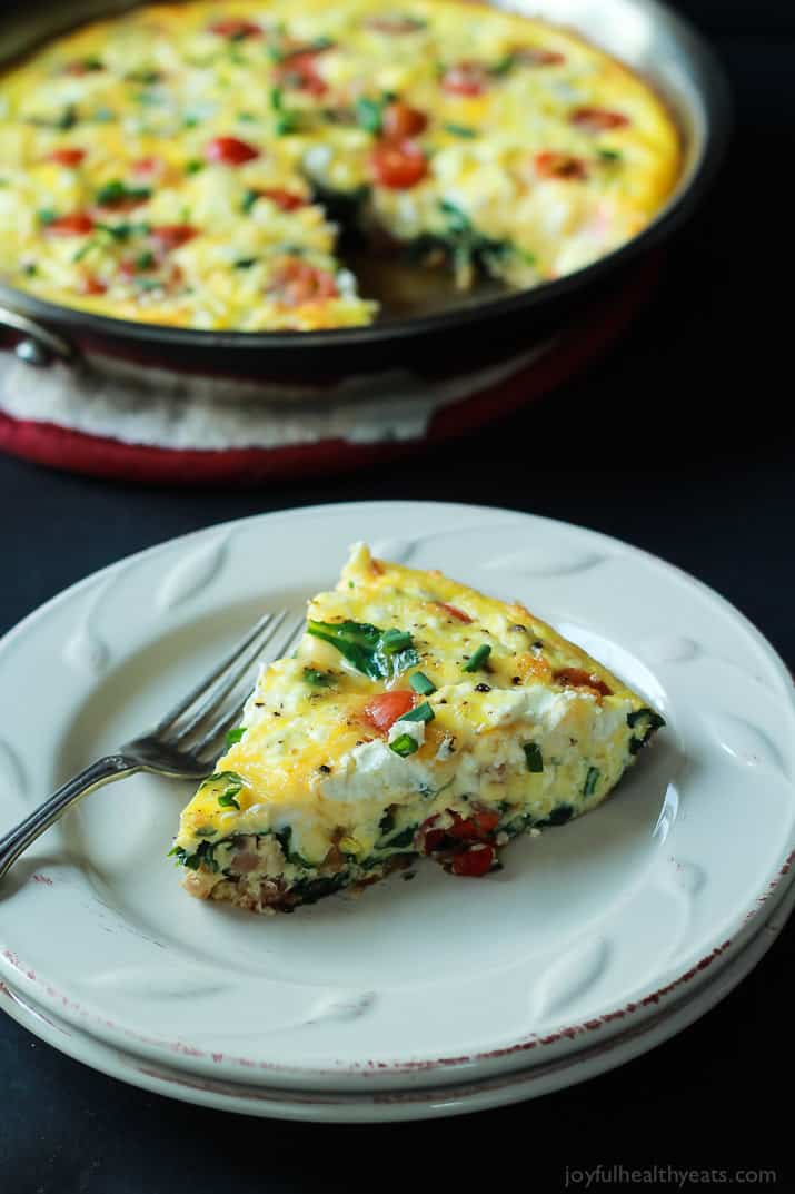 A slice of Cheesy Bacon Spinach Frittata on a plate